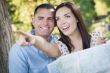 Mixed Race Couple Looking Over Map Outside Together