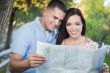 Mixed Race Couple Looking Over Map Outside Together