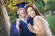 Male Graduate in Cap and Gown and Girl Celebrate