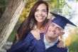 Male Graduate in Cap and Gown and Girl Celebrate