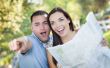 Mixed Race Couple Looking Over Map Outside Together
