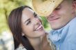 Mixed Race Romantic Couple with Cowboy Hat Flirting in Park