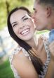 Mixed Race Romantic Couple Whispering in the Park