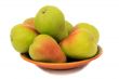 Ripe pears on the plate on a white background.