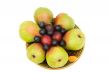 Pears, plums and prunes on the plate on a white background.