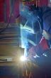 welder with protective mask welding metal