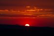 The red sunset sky with the sun and clouds