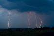 Lightning bolt striking in the sky from clouds