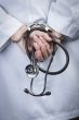 Female Doctor or Nurse In Handcuffs Holding Stethoscope
