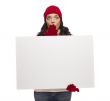 Stunned Girl Wearing Winter Hat and Gloves Holds Blank Sign 