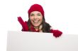 Thrilled Girl Wearing Winter Hat and Gloves Holds Blank Sign 