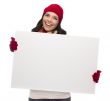 Excited Girl Wearing Winter Hat and Gloves Holds Blank Sign 