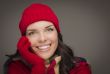 Smilng Mixed Race Woman Wearing Winter Hat and Gloves 