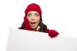Shocked Girl Wearing Winter Hat and Gloves Holds Blank Sign 