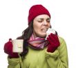 Sick Mixed Race Woman Drinks Hot Tea While Blowing Nose 