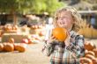Little Boy Holding His Pumpkin at a Pumpkin Patch