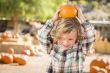 Little Boy Holding His Pumpkin at a Pumpkin Patch