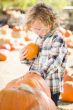 Little Boy Holding His Pumpkin at a Pumpkin Patch