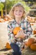 Little Boy Holding His Pumpkin at a Pumpkin Patch
