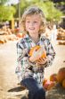 Little Boy Holding His Pumpkin at a Pumpkin Patch