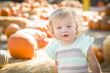 Adorable Baby Girl Having Fun at the Pumpkin Patch