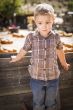 Little Boy Standing Against Old Wood Wagon at Pumpkin Patch