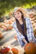 Preteen Girl Playing with a Wheelbarrow at the Pumpkin Patch