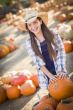 Preteen Girl Playing with a Wheelbarrow at the Pumpkin Patch