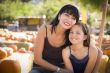 Attractive Mother and Daughter Portrait at the Pumpkin Patch