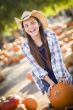 Preteen Girl Playing with a Wheelbarrow at the Pumpkin Patch