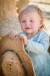 Adorable Baby Girl with Cowboy Hat at the Pumpkin Patch