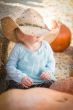 Adorable Baby Girl with Cowboy Hat at the Pumpkin Patch