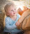 Adorable Baby Girl with Cowboy Hat at the Pumpkin Patch