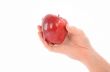 A Hand Holding a Red Apple on White