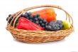 Red, yellow pepper and grapes in a wicker basket on a white back