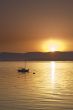 Sunset over the sea with sailing boat