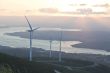 Wind turbine farm with rays of light at sunset