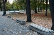 Several park benches facing each other for the autumn day.