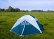 Private camping tent on the meadow near the river.