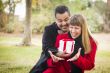 Mixed Race Couple Sharing Christmas or Valentines Day Gift Outsi