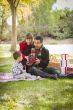 Mixed Race Family Enjoying Christmas Gifts in the Park Together