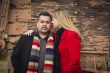 Mixed Race Couple Portrait in Winter Clothing Against Rustic Tra