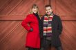 Mixed Race Couple Portrait in Winter Clothing Against Barn Door