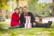 Mixed Race Family Enjoying Christmas Gifts in the Park Together