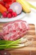 chopping fresh pork ribs and vegetables