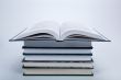 open book on a pile of books