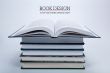 open book on a pile of books