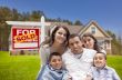 Hispanic Family, New Home and Sold Real Estate Sign