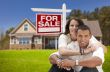 Hispanic Couple, New Home and For Sale Real Estate Sign