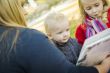 Mother Reading a Book to Her Two Adorable Blonde Children